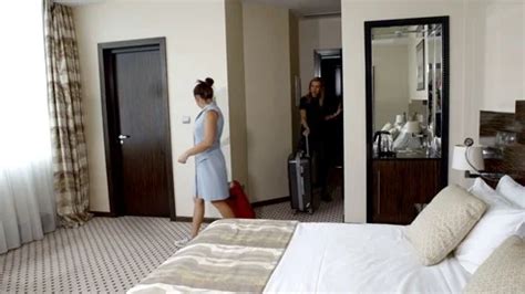 lesbian three some|Two girls lesbian checking in to the hotel room. Vacation together。